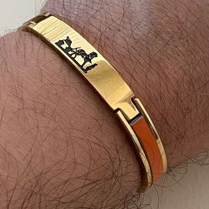 Gold bracelet with orange leather details